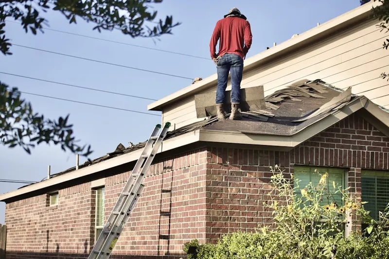 Professional roofer working on a residential roof in Downtown Salem